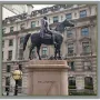 The Duke of Wellington equestrian monument on a granite pedestal in front of a stone building.