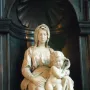 Madonna of Bruges marble sculpture of a seated woman holding a nude infant in an ornate niche