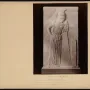 Stone relief of Mourning Athena, shown with her head bowed and leaning on a spear beside a rectangular stele.