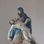 Nenningen Pietà sculpture showing Mary in blue and pink robes holding the lifeless body of Christ across her lap