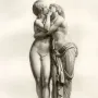 Engraving of Cupid and Psyche embracing and kissing on a round pedestal.