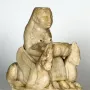 Lady of Galera seated stone figurine holding a bowl, flanked by winged creatures