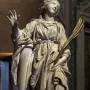 St Bibiana by Bernini, a marble statue of a female figure in flowing robes holding a palm frond.