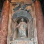 Tomb of Countess Matilda of Tuscany with a standing marble figure in an arched niche, flanked by cherubs and ornate carvings.