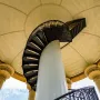 Spiral staircase inside the Hermann Heights Monument leading up to a patterned domed ceiling.