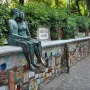 The Muretto of Alassio, a stone wall covered with colorful signed ceramic tiles and a bronze couple sculpture.