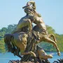 Centauress and Faun sculpture showing a female centaur rearing while kissing a man on her back.