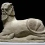 Bicha of Balazote stone sculpture with a bearded human head and reclining animal body