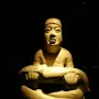 Las Limas figurine showing a cross-legged stone figure holding a smaller figure across its lap.