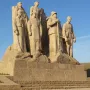 The Ghosts stone sculpture of several uniformed men on a stepped base with French lettering.