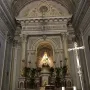 Crowned statue of Madonna dell\'Udienza in an ornate church niche above a marble altar.