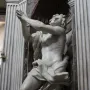 Bernini\'s Daniel and the Lion in white marble, shown kneeling with arms raised in a dark niche.