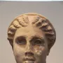 Marble head of Lycosoura Artemis with wavy braided hair swept back