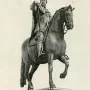 Ferdinando I de\' Medici equestrian statue showing a bearded armored rider on a horse atop a tall pedestal.