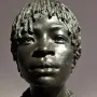 Bronze bust of Woman of Central Africa with short textured hair and layered beaded necklaces on a dark base.
