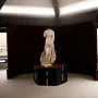 Venus Landolina marble statue standing on a dark pedestal in a museum gallery.