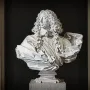 Bust of Francesco I d\'Este in white marble, showing a man with a curly wig and ruffled collar on a pedestal.