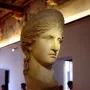 Juno Ludovisi marble bust with wavy hair and a composed expression on a decorated pedestal.