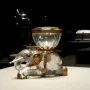 Elephant with Salt Cellar featuring a clear elephant figure with gold details and a ribbed glass bowl on its back.