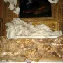 Close-up of Bernini’s Ecstasy of Blessed Ludovica Albertoni, showing the recumbent marble figure’s face, drapery, and carved pillow.