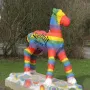 Holbeinpferd concrete foal sculpture painted with rainbow stripes and the text \