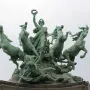 Immortality Overtaking Time sculpture with a female figure raising a wreath above a chariot pulled by four horses