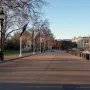 Horse Guards Memorial beside Horse Guards Road, with flagpoles, bollards, and a large historic building in the background.