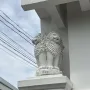 White Lion Capital of Ashoka sculpture with lions back-to-back on a pedestal and a carved circular base.