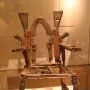 Throne of Weapons sculpture made from rusted gun parts and firearm components.