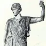 Athena Lemnia statue of a draped female figure with her head turned left and one arm raised holding a cylindrical object.