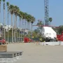 Levitated Mass boulder wrapped in white plastic on a transport vehicle at a construction site.
