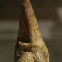 Venus of Savignano stone figurine with a stylized female torso on a stand.