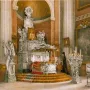 Alexander Nevsky reliquary with a tiered metallic altar, sculptural figures, and a central portrait inside a grand interior