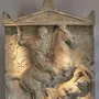 Stele of Dexileus showing a cloaked rider on a rearing horse above a fallen figure, with an inscribed stone base below.