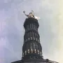 Victory Column seen from below, with a golden winged statue on top of the column.