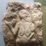 Venus of Laussel limestone relief showing a standing female figure holding a curved horn-like object.