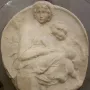 Pitti Tondo marble relief showing a seated woman with two children.