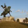 Suvorov Monument, a bronze equestrian statue of Alexander Suvorov on a stone base with flags and a building in the background.
