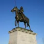 Tadeusz Kościuszko Monument showing a bronze equestrian statue of a man in military attire with a raised sword on a stone pedestal.
