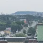 The Liberty Statue appears as a distant silhouette atop a hill.