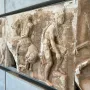 Parthenon frieze marble relief with horsemen and a draped figure