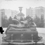 The Great God Pan bronze statue reclining and playing a pipe beside a fountain basin.