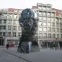 The Head of Franz Kafka sculpture in Prague, a towering reflective head made of horizontal mirrored panels.