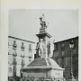 Monument to Vincenzo Bellini with a seated figure atop a tall pedestal and standing allegorical statues below