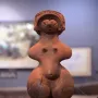 Jōmon Venus clay figurine with a patterned headdress, broad hips, and a rounded belly