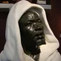 Salem, Negro of Sudan, a dark metal bust of a bearded man in a white hooded garment.
