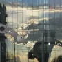 S-Printing Horse sculpture reflected in a glass building at sunset