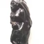 Oviri sculpture by Paul Gauguin, a dark standing figure with long flowing hair and an animal form at the base.