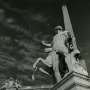 The Horse Tamers sculpture seen from behind, with a rearing horse and an obelisk rising in the background.