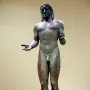 Piraeus Apollo bronze statue of a nude male figure with long hair and outstretched arms